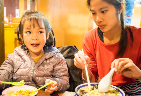 Feeding Japanese baby girlの写真素材