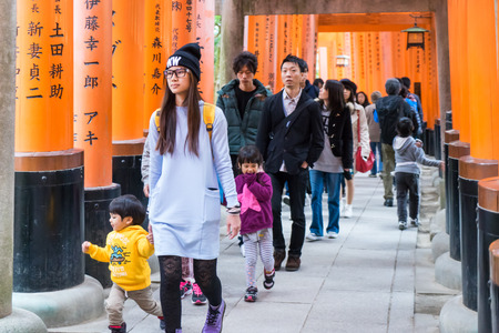 Kyoto, Japan - March 13, 2016: Tourist are walking through Fushimi Inari's orange gates.のeditorial素材