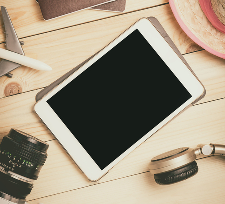Blank tablet screen template mock up for summer travel equipments. Empty tablet screen for Vacation and travel agency website or travel advertisement.の写真素材