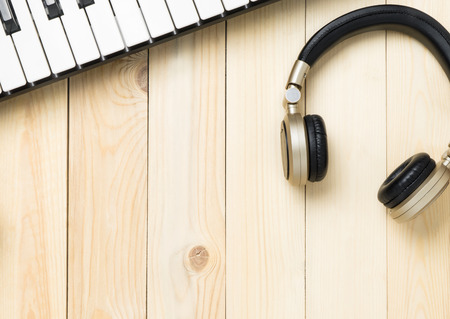 Music keyboard with headphone wooden backgroundの写真素材