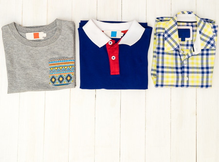 Little boy fashion shirts on white wooden table with copy spaceの写真素材
