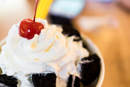 Whipped Cream with red cherry on top of an ice cream bowlの写真素材