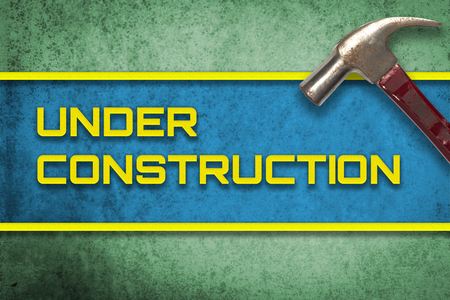 Under Construction green yellow banner with hammerの写真素材