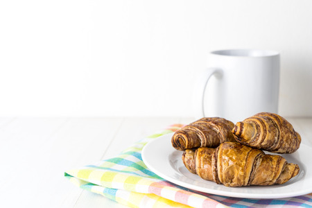 Chocolate croissant and coffee mug with white copy spaceの写真素材