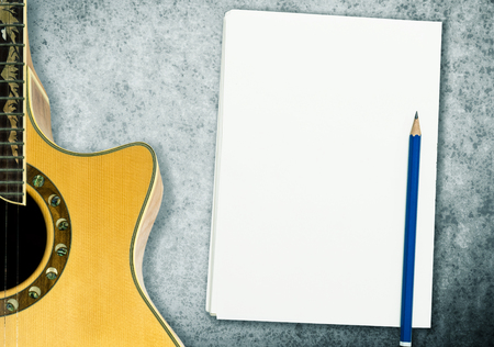 Music Song Writing with blank notebook and guitarの写真素材