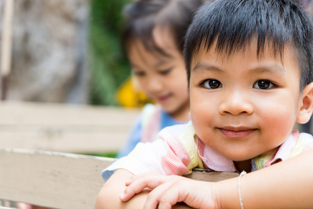 Happy Asian children are riding on a truck. Smiling Asian boy face with her sister on the background. Happy Asian children with copy space.の写真素材