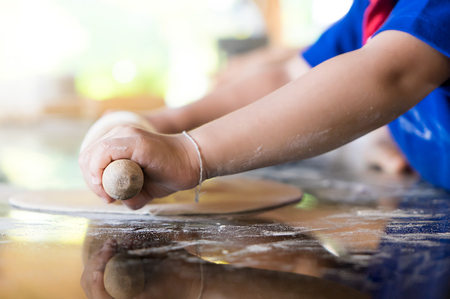 Little kid learning for to make bakery and pizza in an educational cooking class. Educational Cooking and Baking class for children can improve their creativity and also muscle movement.の写真素材