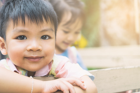 Happy Asian children are riding on a truck. Smiling Asian boy face with her sister on the background. Happy Asian children with copy space.の写真素材