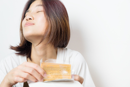 Asian female expression of The Cake is smelling so goodの写真素材