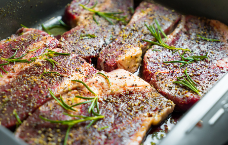 Raw Beef Steak with spices and seasoning preparation for grill.の写真素材