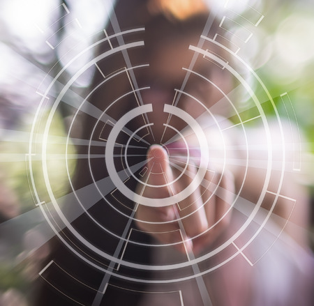 Blurred women pointing at the air with technology circle symbol.の写真素材