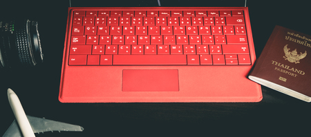 Computer and Business travel equipment on black table.の写真素材