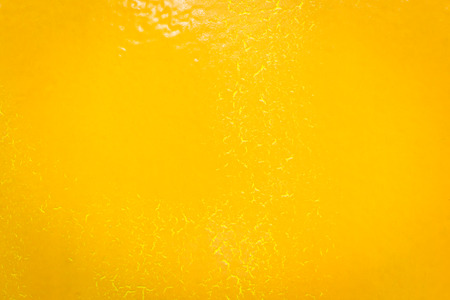 Orange wall with stained paint breaking out texture background.の写真素材