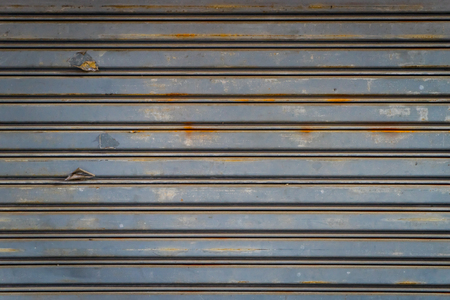 Gray Rustic store retail metal gate wall closed.の写真素材