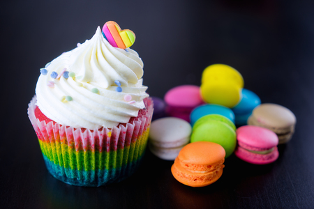 Colorful Rainbow valentine cupcake with macaron.の写真素材