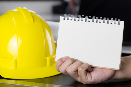 Construction worker holding blank book for text space.の写真素材