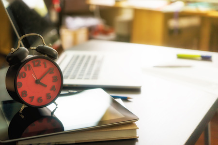 Alarm clock on office table for office deadline conceptの写真素材