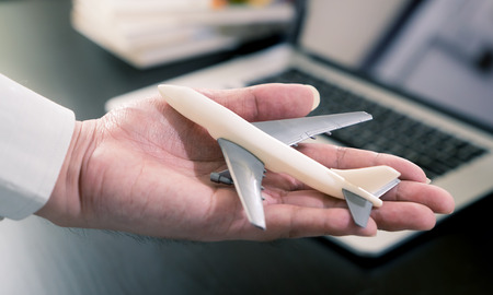 Business Man holding airplane for business travel concept.の写真素材