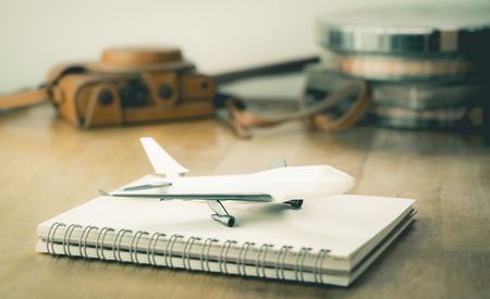Vintage Travel blogger accesories with toy plane travel conceptの写真素材