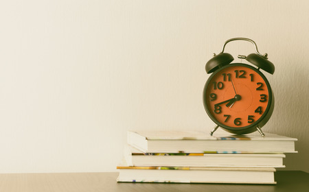 Red Alarm clock on office tableの写真素材
