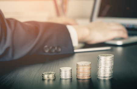 Business man is investing on Stock exchange on his computerの写真素材