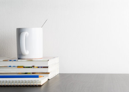 Coffee mug on writing working desk with copy space