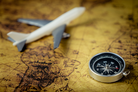 Retro Compass with toy airplane on Vintage world map for explorer conceptの写真素材