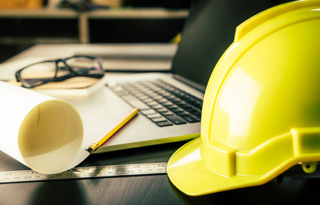 Engineer Architect working table with safety helmetの写真素材