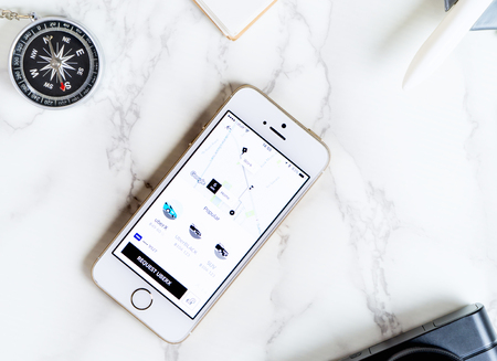 Bangkok, Thailand - March 12, 2017: Traveler is using Uber application on iPhone to travel.のeditorial素材