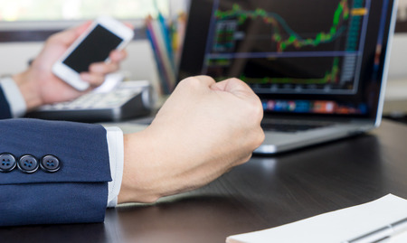 Business man trading stock on computer succesfullyの写真素材