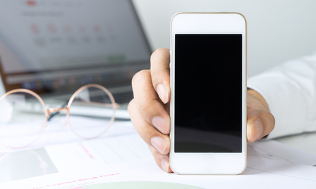 Business man is holding blank screen phone for mock upの写真素材