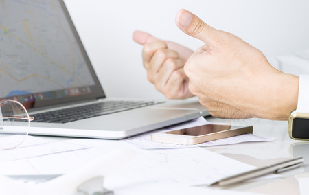 Business man is optimistic with two thumbs upの写真素材