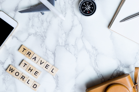 World Explorer blogger accessories on luxury white marble table with copy space in middleの写真素材