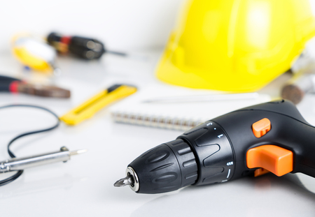 Repair man, construction worker tools on white background. Focus on screwdriverの写真素材