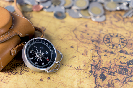 Vintage world Explorer equipment with camera and compass on vintage mapの写真素材