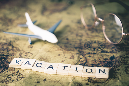 Vacation concept text and traveler equipment on vintage mapの写真素材
