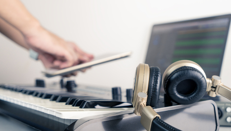 Musician using table to control Music studio working desktop applicationの写真素材
