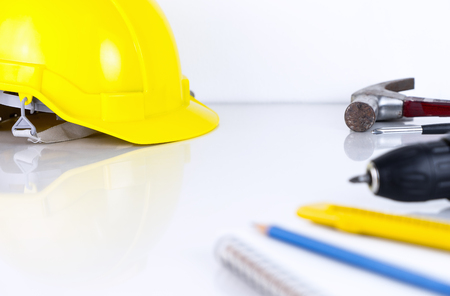 Engineer construction Helmet and tools on office tableの写真素材