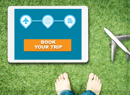 Book your vacation Trip on tablet and start walkingの写真素材