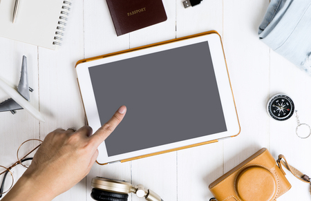 Hand touching blank tablet mock up screen for travel and tourism themeの写真素材