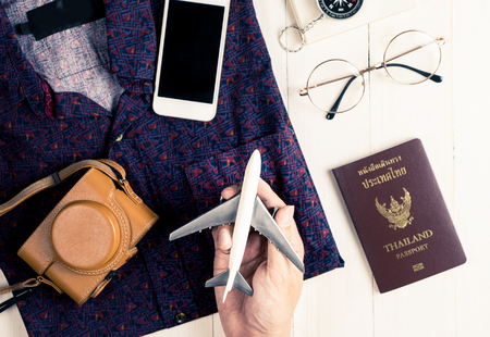 Man holding toy plane for travel accessories flat layの写真素材