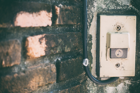 Rustic front gate door bell on brick wall gateの写真素材