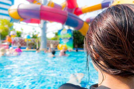 Asian girl is relaxing on the beach poolsideの写真素材