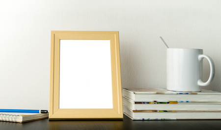 Blank photo frame for picture mock up on working tableの写真素材