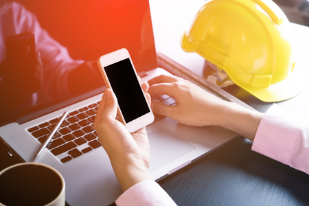 Engineer holding a blank smartphone screen for smartphone engineering application mock upの写真素材