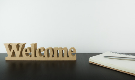 Welcome sign with notebook on office table with copy spaceの写真素材