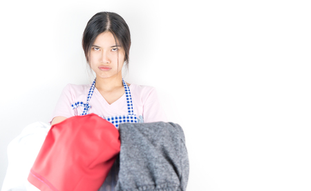 Housewife is tried and angry with a lot of clothes for laudryの写真素材