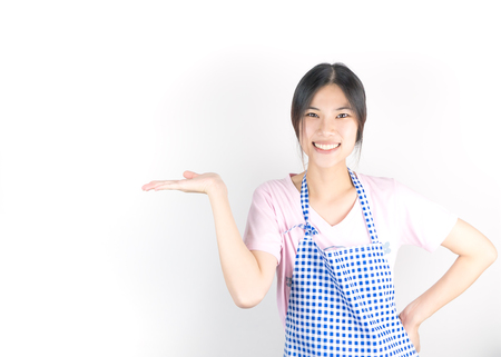 Happy asian housewife maid is presenting copy spaceの写真素材