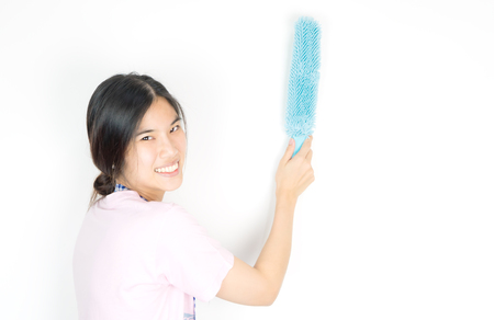 Asian house cleaner using dust cleaner on the wallの写真素材