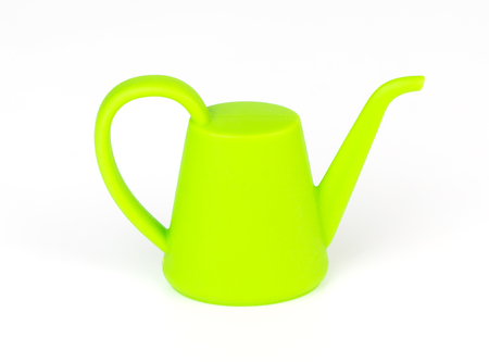 Green plastic garden watering pot isoalted on whiteの写真素材